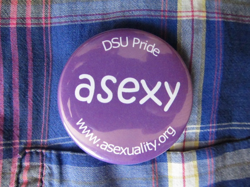 Button that says asexy on the interviewee's shirt